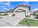 Attached two-car garage with a clean concrete driveway and well-maintained landscaping at 23753 S Vacation Way, Sun Lakes, AZ 85248