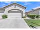 Attached two-car garage with a clean concrete driveway and well-maintained landscaping at 23753 S Vacation Way, Sun Lakes, AZ 85248