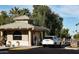 Charming Oakwood Country Club guard house with a security guard and well-maintained landscaping at 23753 S Vacation Way, Sun Lakes, AZ 85248
