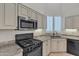 Stylish kitchen featuring stainless steel appliances, tile floors and stone countertops at 23753 S Vacation Way, Sun Lakes, AZ 85248