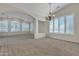 Spacious living room featuring plush carpeting and plantation shutters for natural light at 23753 S Vacation Way, Sun Lakes, AZ 85248