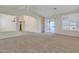 Bright living room with neutral decor, carpet flooring and sliding door access at 23753 S Vacation Way, Sun Lakes, AZ 85248
