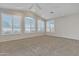 Spacious room featuring vaulted ceilings, multiple windows, and plush carpet at 23753 S Vacation Way, Sun Lakes, AZ 85248