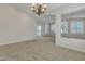 Bright living space with neutral walls, carpet flooring, and an ornate chandelier at 23753 S Vacation Way, Sun Lakes, AZ 85248