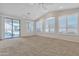 Open living room with vaulted ceilings, ceiling fans, and sliding glass doors at 23753 S Vacation Way, Sun Lakes, AZ 85248