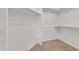 Spacious walk-in closet featuring carpeted floor and installed shelving at 23753 S Vacation Way, Sun Lakes, AZ 85248