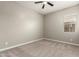 Empty bedroom featuring neutral tones, a ceiling fan, and a window at 24478 N 166Th Ave, Surprise, AZ 85387