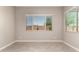 Bright, empty bedroom featuring neutral tones and tile flooring at 24478 N 166Th Ave, Surprise, AZ 85387