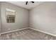 Neutral bedroom with window, neutral paint, carpet flooring, and ceiling fan at 24478 N 166Th Ave, Surprise, AZ 85387