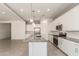 Modern kitchen featuring white cabinets and gray granite countertops at 24478 N 166Th Ave, Surprise, AZ 85387