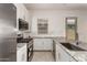 Modern kitchen features granite counters, white cabinetry, and stainless steel appliances at 24478 N 166Th Ave, Surprise, AZ 85387