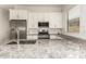 Well-appointed kitchen features granite counters, modern appliances, and white cabinetry at 24478 N 166Th Ave, Surprise, AZ 85387