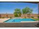 Backyard swimming pool features a stone waterfall, creating a serene outdoor oasis at 24478 N 166Th Ave, Surprise, AZ 85387