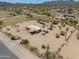 Aerial shot of a desert home and its expansive lot with sparse vegetation and mountain views at 270 S Ralston Rd, Maricopa, AZ 85139