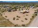 Overhead view of desert property with arid vegetation, adjacent homes, and clear sky at 270 S Ralston Rd, Maricopa, AZ 85139