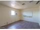 Bedroom with dark wood-look flooring, a single window, and poor wall repair at 270 S Ralston Rd, Maricopa, AZ 85139