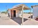Exterior view of a small, weathered shed with an open-air covered porch area at 270 S Ralston Rd, Maricopa, AZ 85139