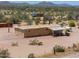 Single-story desert home featuring a low-pitched metal roof and minimal desert landscaping at 270 S Ralston Rd, Maricopa, AZ 85139