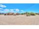 Exterior view of the house and outbuilding, desert terrain, under a blue sky at 270 S Ralston Rd, Maricopa, AZ 85139