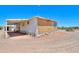 Exterior view of a small home with a covered porch and desert landscape surrounding the property at 270 S Ralston Rd, Maricopa, AZ 85139