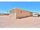Exterior of home with covered porch, yard and desert landscape, and bright blue skies at 270 S Ralston Rd, Maricopa, AZ 85139