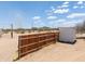 View of a wooden fence with a dirt lot on a sunny day with blue sky and clouds at 270 S Ralston Rd, Maricopa, AZ 85139