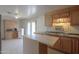 An eat-in kitchen with wooden cabinets, a stainless steel sink, and a center island at 270 S Ralston Rd, Maricopa, AZ 85139