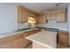 Spacious kitchen with wood cabinets, an island, stainless appliances and laminate floor at 270 S Ralston Rd, Maricopa, AZ 85139