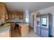A kitchen with stainless steel appliances, an island, wood cabinets and laminate floor at 270 S Ralston Rd, Maricopa, AZ 85139