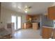 Kitchen with wood cabinets and stainless steel refrigerator leading to the backyard at 270 S Ralston Rd, Maricopa, AZ 85139