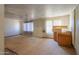 Spacious living room area with a ceiling fan, large windows, and partial kitchen at 270 S Ralston Rd, Maricopa, AZ 85139
