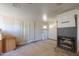 View of a fireplace, a doorway, and window in a spacious living room with neutral walls at 270 S Ralston Rd, Maricopa, AZ 85139