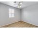 Bedroom with a ceiling fan, wood-look floors, and ample natural light from the window at 2941 E Darrow St, Phoenix, AZ 85042
