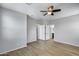 Bright bedroom with wood-look floors, ceiling fan, closet, and doorway to other rooms at 2941 E Darrow St, Phoenix, AZ 85042
