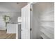 A well-organized walk in closet with wooden floors, shelving, and neutral paint at 2941 E Darrow St, Phoenix, AZ 85042