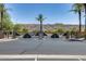 Community entrance with palm trees and a security gate against a mountain backdrop at 2941 E Darrow St, Phoenix, AZ 85042