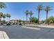 Community entrance with palm trees and a security gate leading to the homes beyond at 2941 E Darrow St, Phoenix, AZ 85042