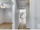 Bright hallway with wood-look floors leading to a living space with a ceiling fan at 2941 E Darrow St, Phoenix, AZ 85042