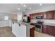 Well-lit kitchen featuring stainless steel appliances, granite countertops, and a breakfast bar at 2941 E Darrow St, Phoenix, AZ 85042