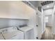 A laundry room featuring a white washer and dryer, white walls, and wood-look tile flooring at 2941 E Darrow St, Phoenix, AZ 85042