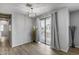 Living room with view to a patio with curtains and a modern chandelier at 2941 E Darrow St, Phoenix, AZ 85042