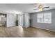 Bright, airy living room featuring hardwood floors, a ceiling fan, and sliding glass doors at 2941 E Darrow St, Phoenix, AZ 85042