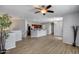 Open-concept living space showcasing hardwood floors, a kitchen bar, and modern lighting at 2941 E Darrow St, Phoenix, AZ 85042