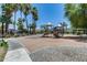 Community playground with slides and climbing structures, surrounded by palm trees and paths at 2941 E Darrow St, Phoenix, AZ 85042