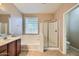 Bathroom featuring a shower, soaking tub, and wooden vanity at 29828 N 72Nd Ln, Peoria, AZ 85383