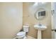 A neutral powder room features a pedestal sink and a round mirror at 29828 N 72Nd Ln, Peoria, AZ 85383