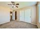 A spacious bedroom with two entryways and a ceiling fan at 29828 N 72Nd Ln, Peoria, AZ 85383