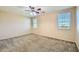 This spacious bedroom has a ceiling fan and two sunlit windows at 29828 N 72Nd Ln, Peoria, AZ 85383