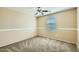 A bedroom with a ceiling fan and two sunlit windows at 29828 N 72Nd Ln, Peoria, AZ 85383