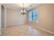 Dining room featuring tile floors, neutral walls, a chandelier, and two windows at 29828 N 72Nd Ln, Peoria, AZ 85383